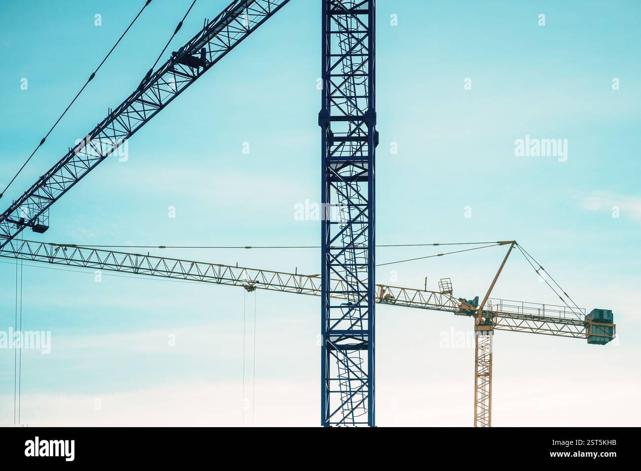 Two construction cranes on site, selective focus Stock Photo