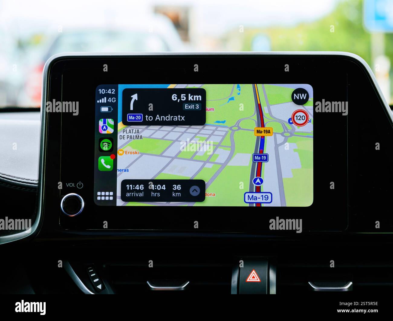 Andratx, Spain - Jun 28, 2023: A car infotainment screen displaying Apple CarPlay navigation with directions to Andratx, Mallorca, Spain, using a maps Stock Photo