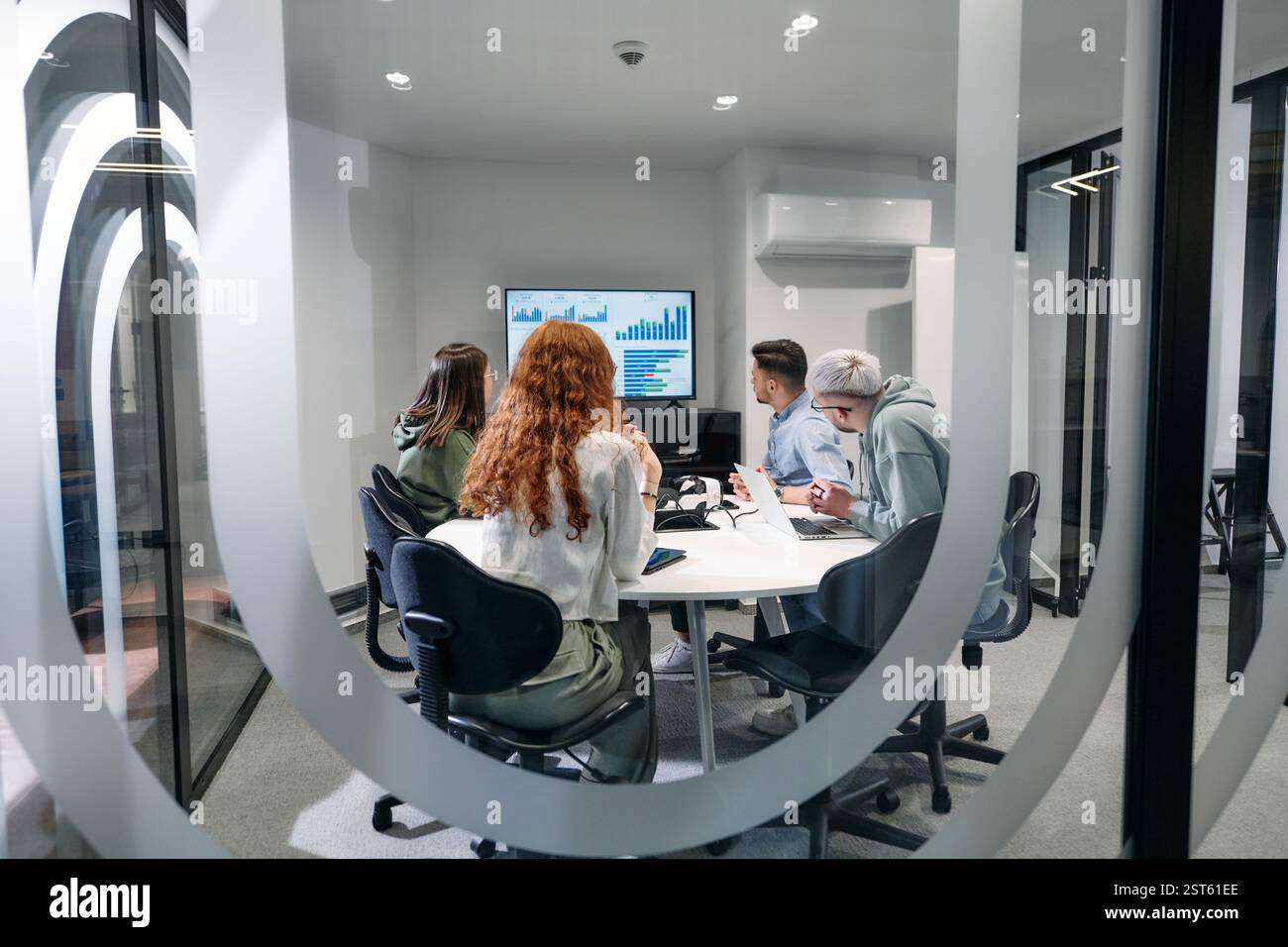 A diverse group of businessmen collaborates and tests a new virtual ...