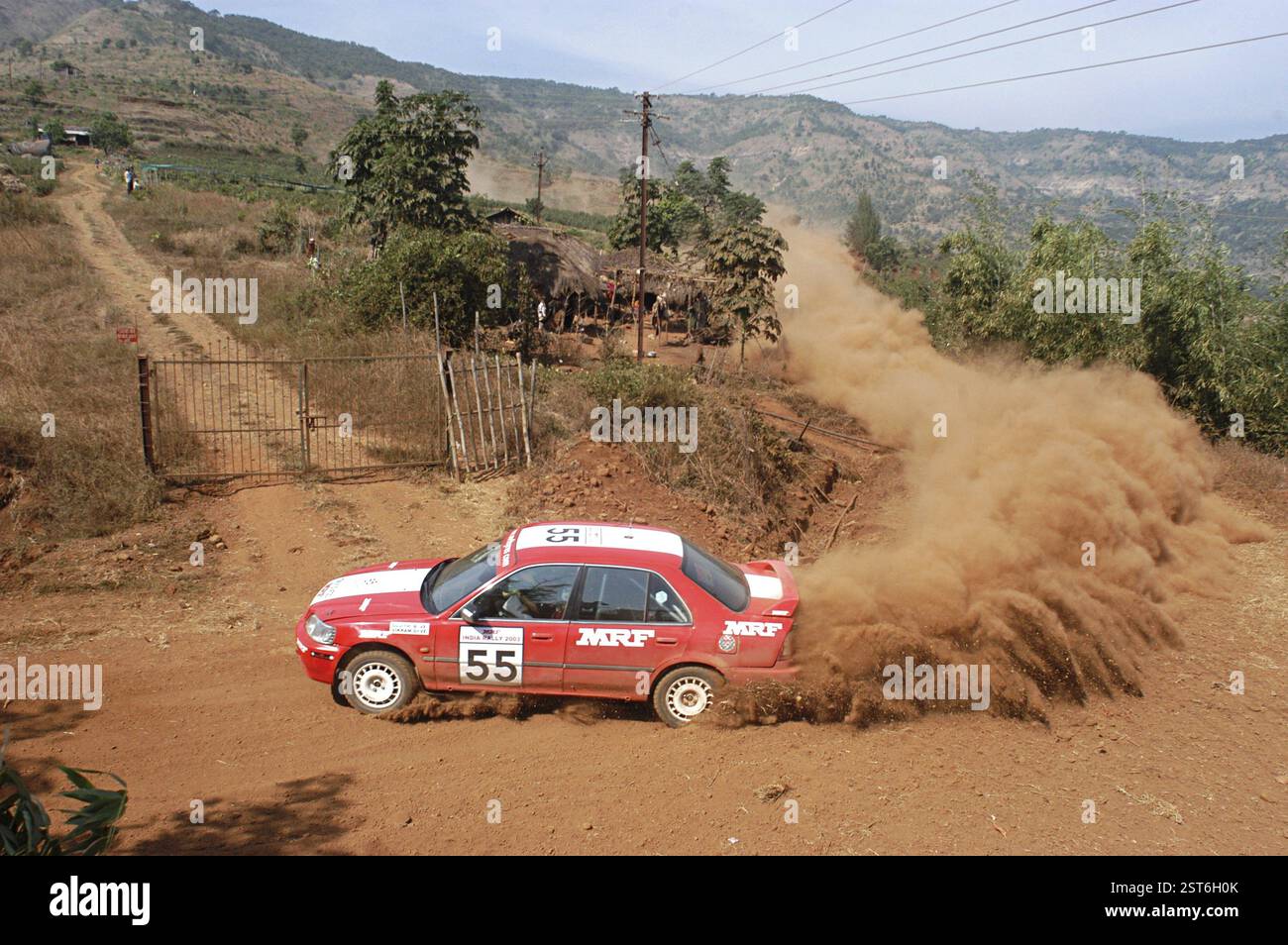 Car passing through the dusty roads at the special stage at Lake City ...