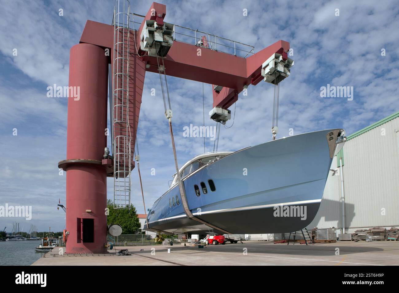 At the shipyard. Blue yacht ready for launch at the yard. Shipbuilding ...