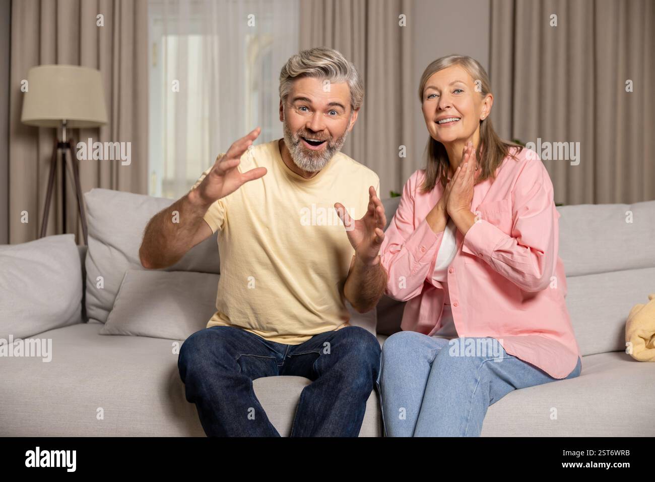 A couple watching a movie together and looking interested Stock Photo
