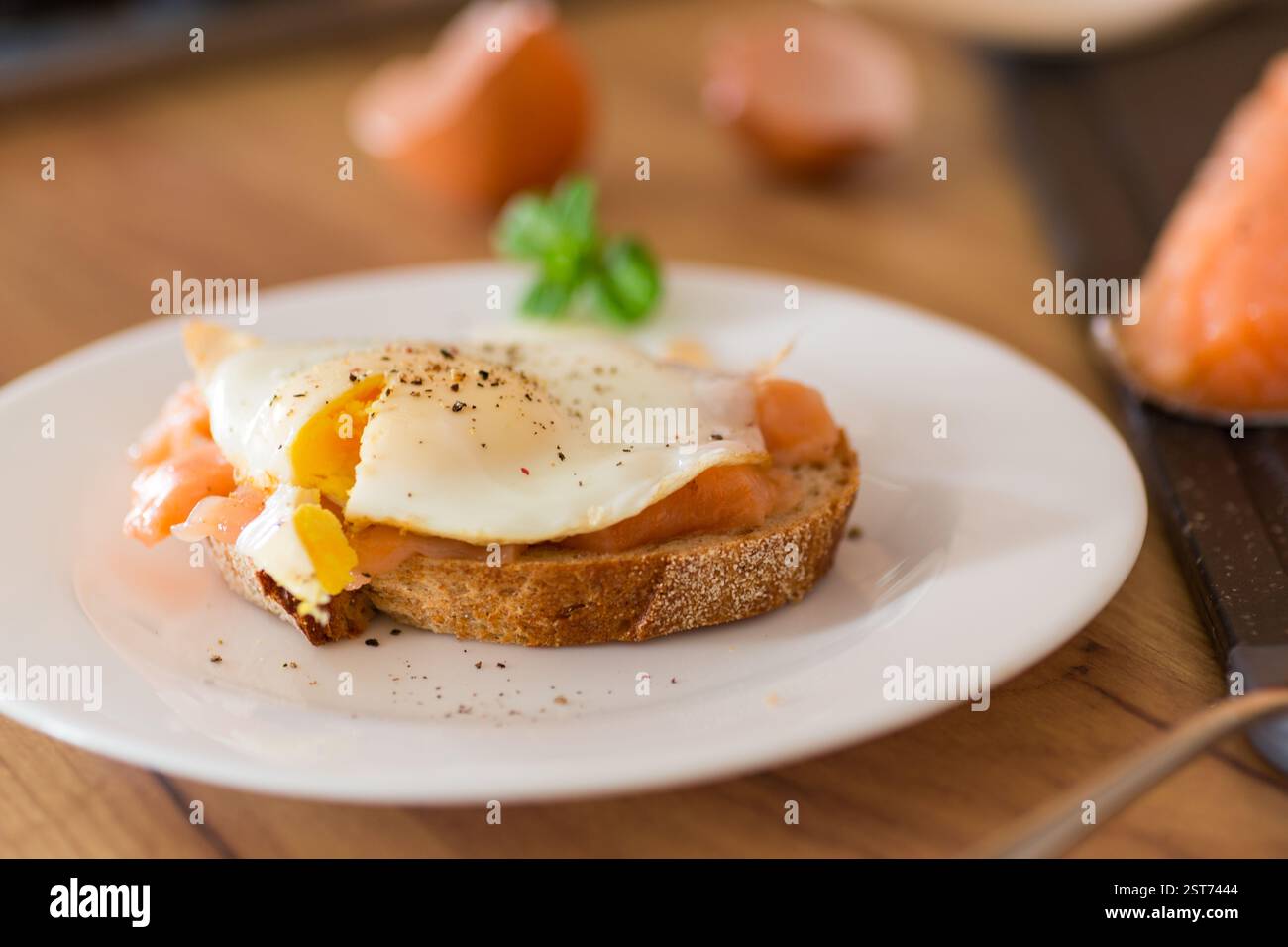 Diet breakfast with cooked egg and lightly salted red fish. Stock Photo