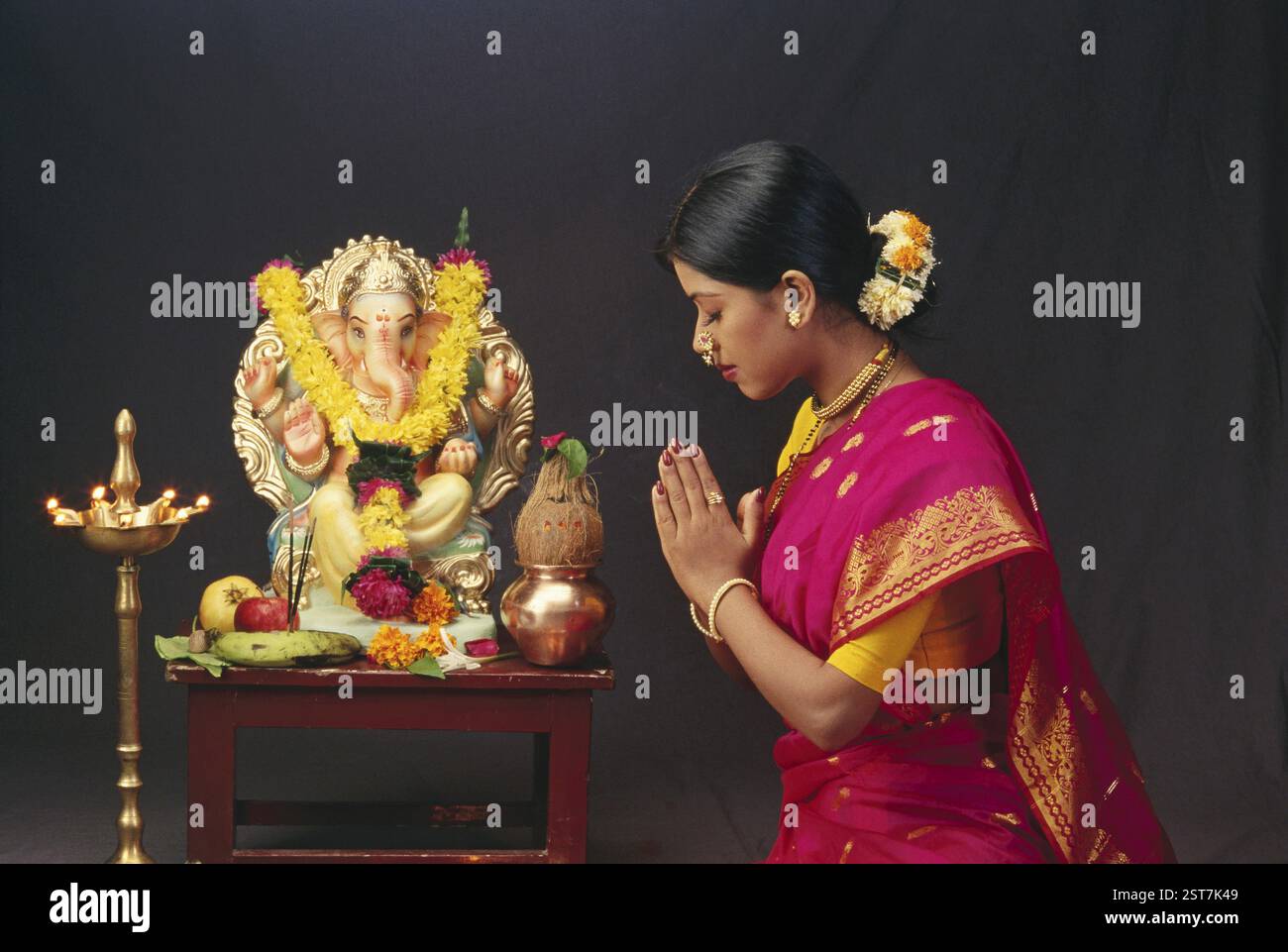 Woman Worshiping idol of Elephant headed God Ganesh ganpati Festival MR.138 Stock Photo