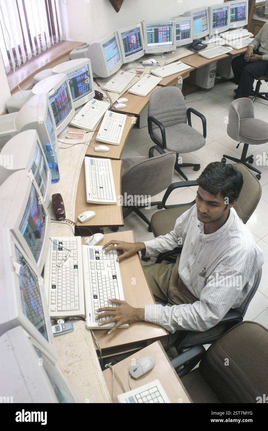 Persons at a office of a stock brokers working online share trading on the Bombay Stock Exchange (BSE) in Bombay now Mumbai in Maharashtra, India, Asi Stock Photo