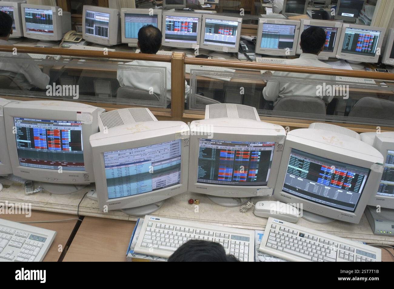 Persons at a office of a stock brokers working online share trading on the Bombay Stock Exchange (BSE) in Bombay now Mumbai in Maharashtra, India, Asi Stock Photo