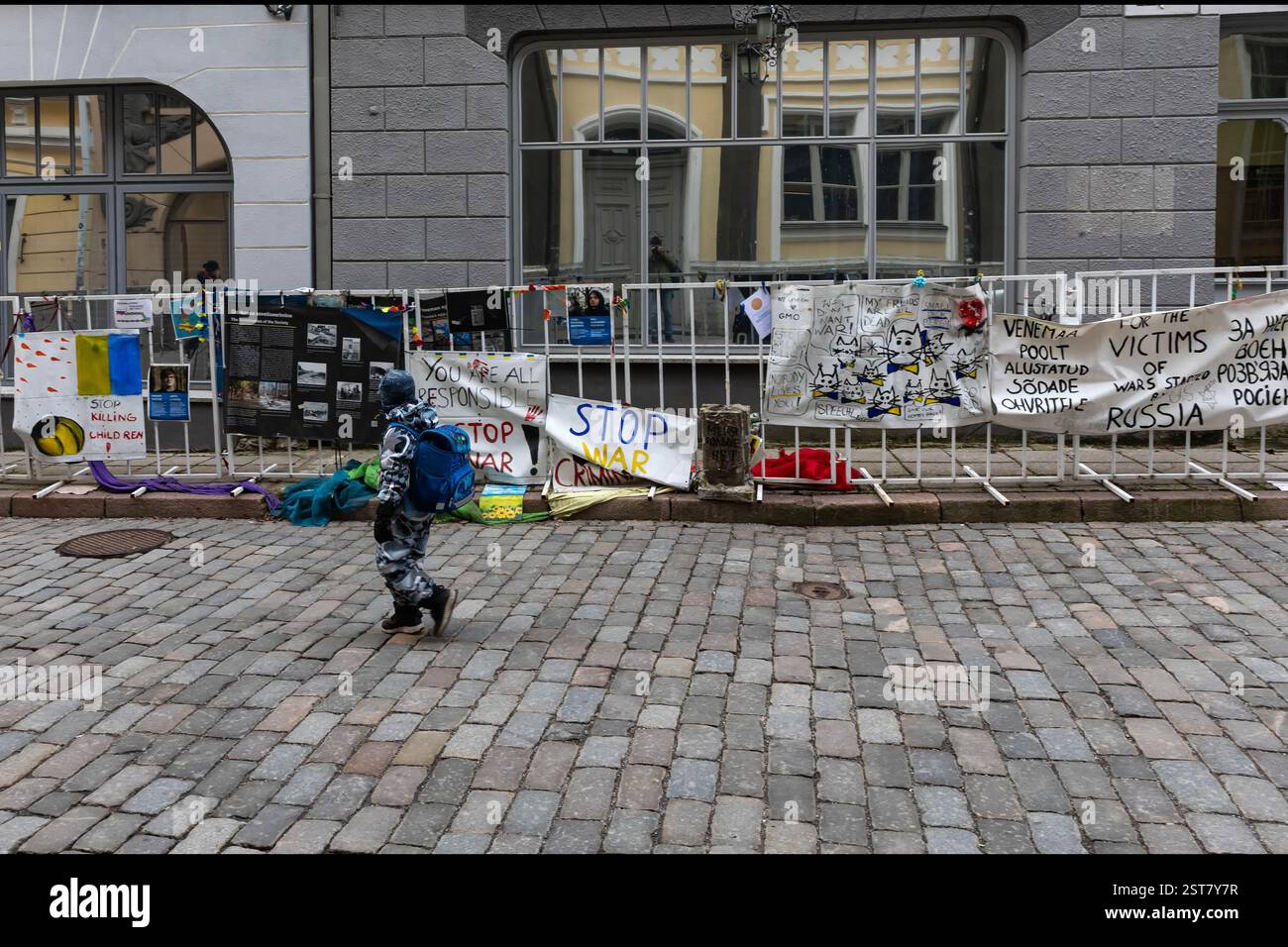 Russian Embassy in Tallinn. Protest posters in front of the embassy against the invasion of Ukraine. A schoolchild walking in front of the posters. Stock Photo