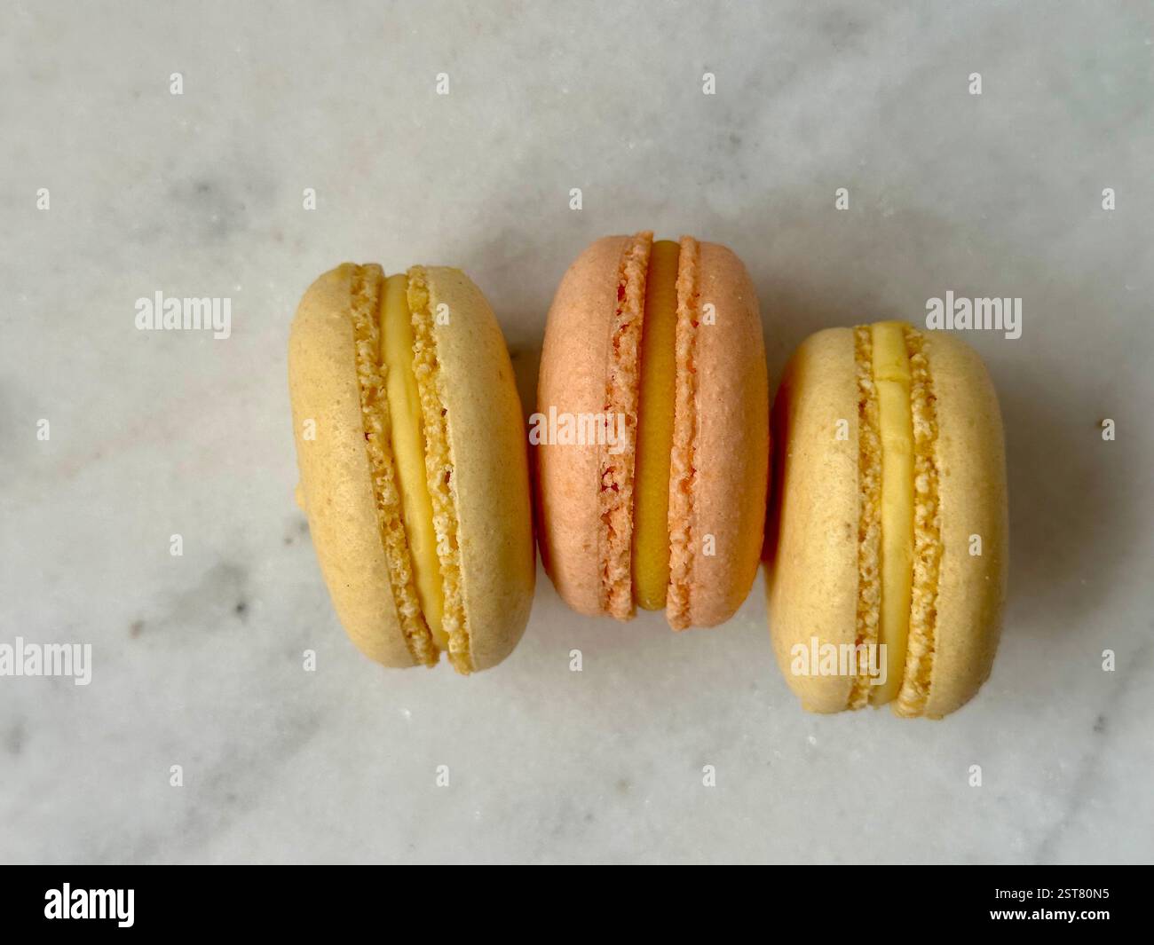 Orange and yellow macarons on the marble background - Smartphone Captured Stock Image