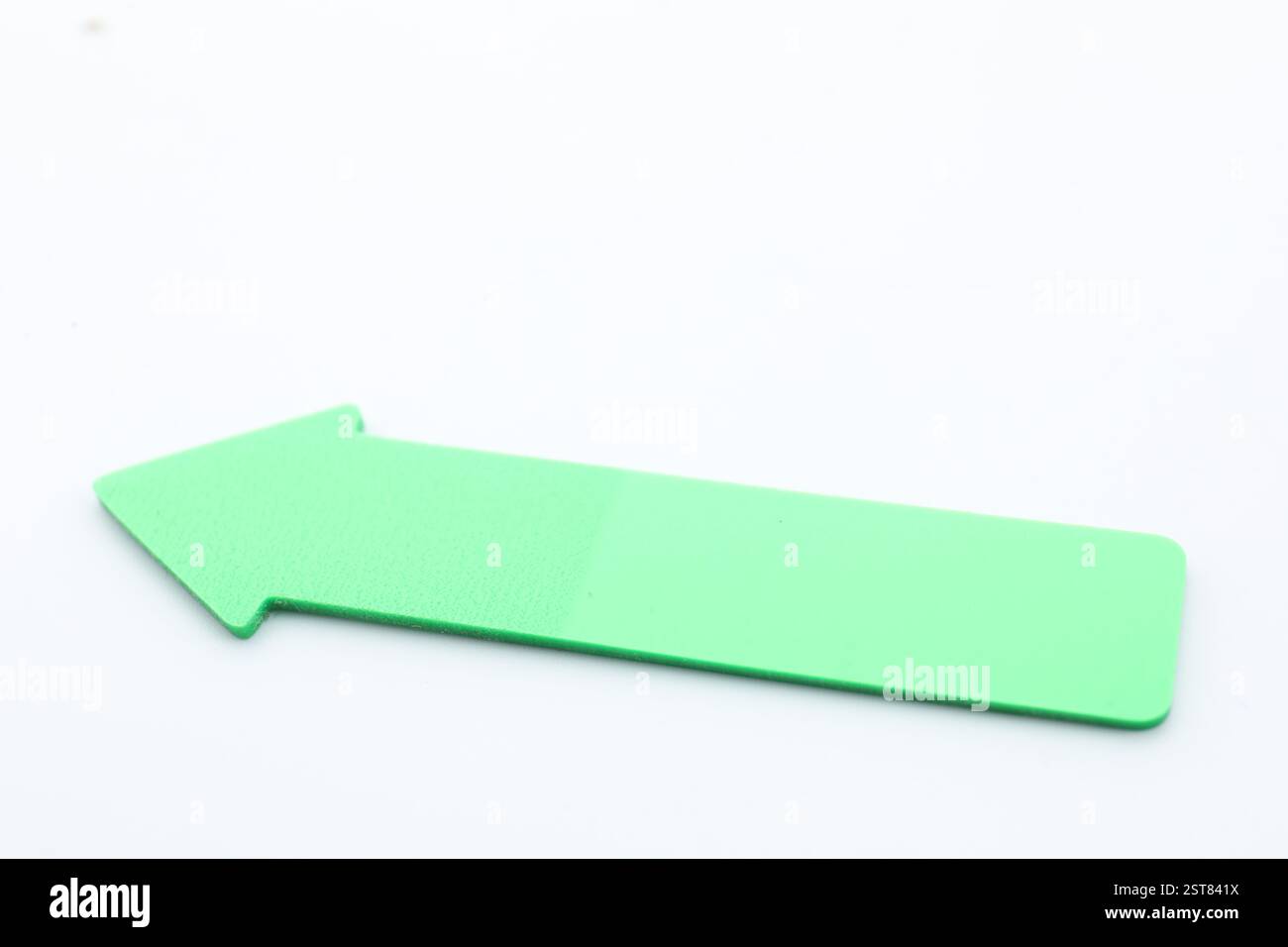 One green paper arrow isolated on white Stock Photo - Alamy