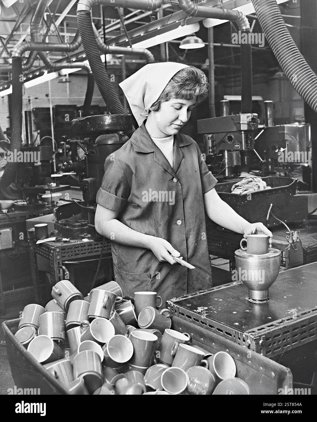 Woman making plastic cups at British Industrial Plastics in Oldbury, West Midlands. 1966 Stock Photo