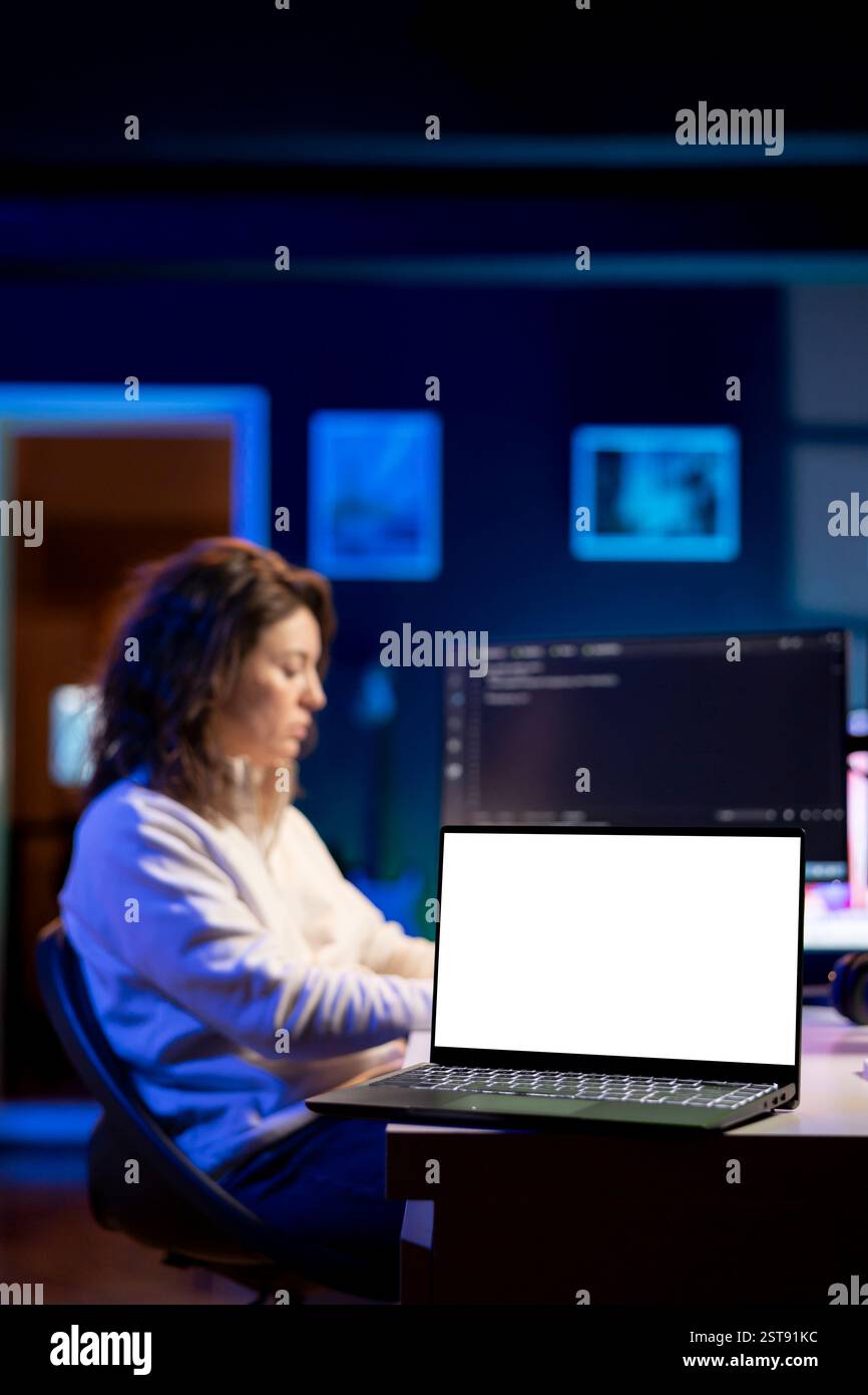 Technician using isolated screen laptop to secure company servers from virus attacks. IT remote employee writing code, building firewalls protecting data using chroma key notebook, solving tasks Stock Photo