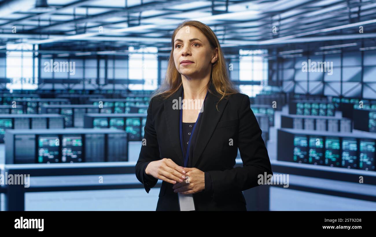 System administrator in high tech data center looking at hologram visualization. Computer scientist working on securing server terminals using AR tech, preventing hacker attacks, camera A Stock Photo