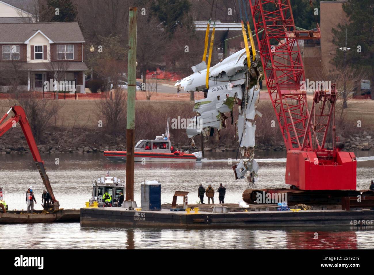 FILE - Rescue and salvage crews with cranes pull up the wreckage of an ...