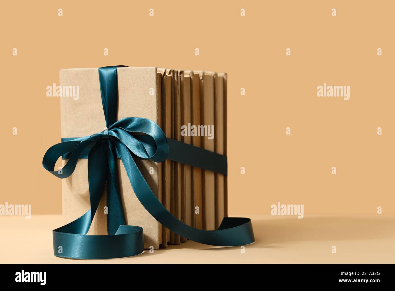 Blue Book Ribbon Shell Stack of books with blue ribbon on beige background Stock Photo - Alamy