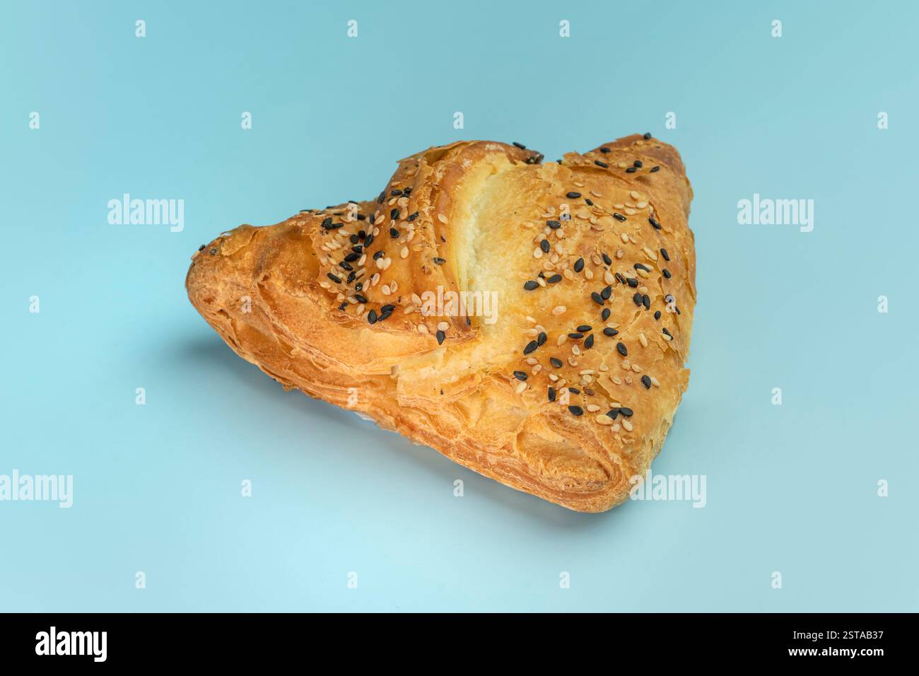 Samsa with meat on a blue background top view. bright blue background color. Stock Photo