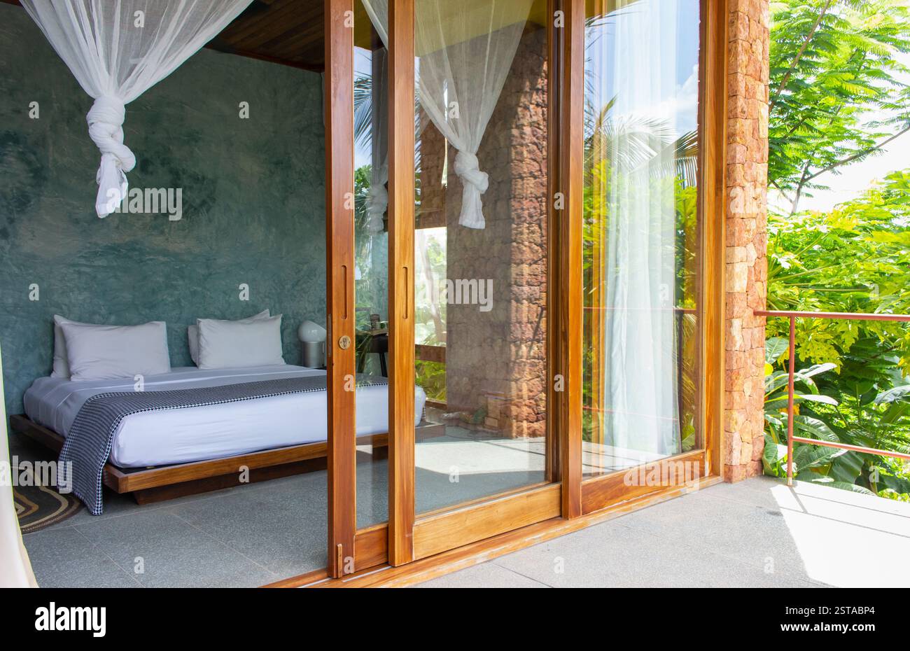 Luxury hotel room with mosquito net and open doorway. Comfortable ...