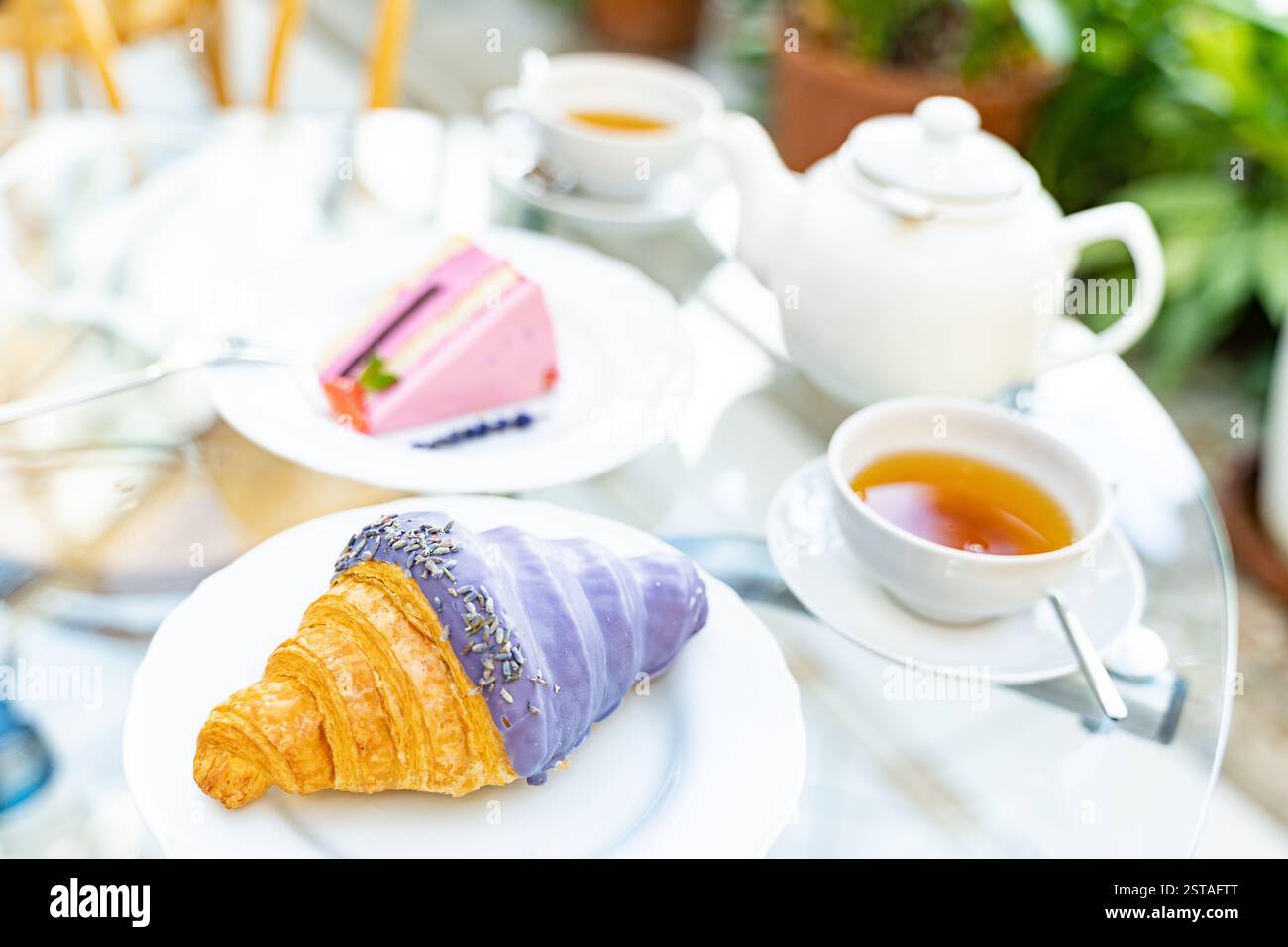 tea with lavender croissant and raspberry cheesecake for breakfast. white cup Stock Photo