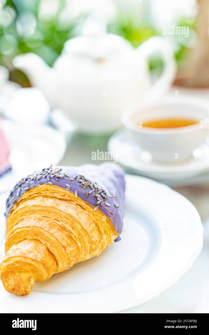 tea with lavender croissant for breakfast. white porcelain service, high key  Stock Photo
