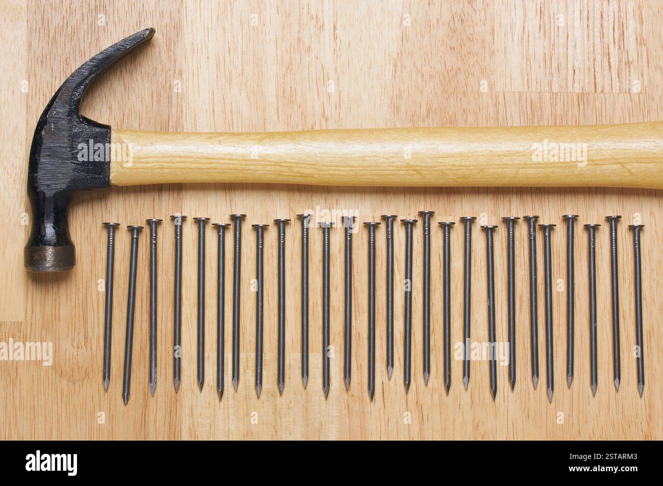 Hammer and Nails Abstract on Wood Background. Stock Photo