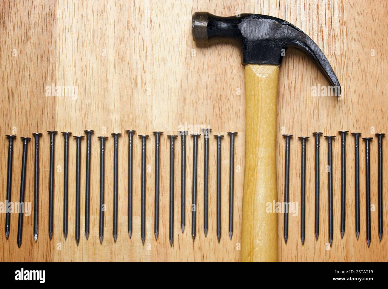 Hammer and Nails Abstract on Wood Background. Stock Photo