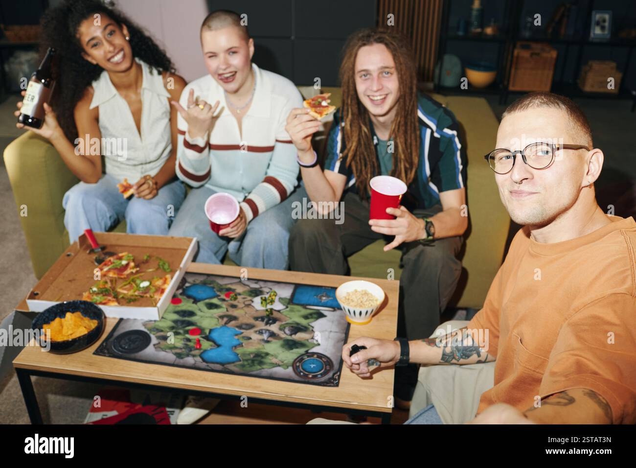 Enjoying Board Game Night with Friends Around Table Stock Photo