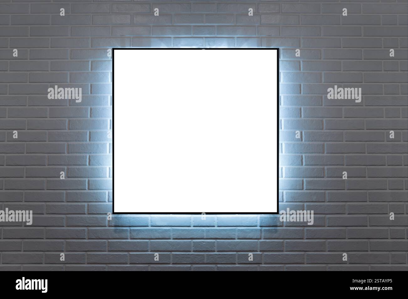 frame 1:1 hanging on a brick wall illuminated wit LED light Stock Photo