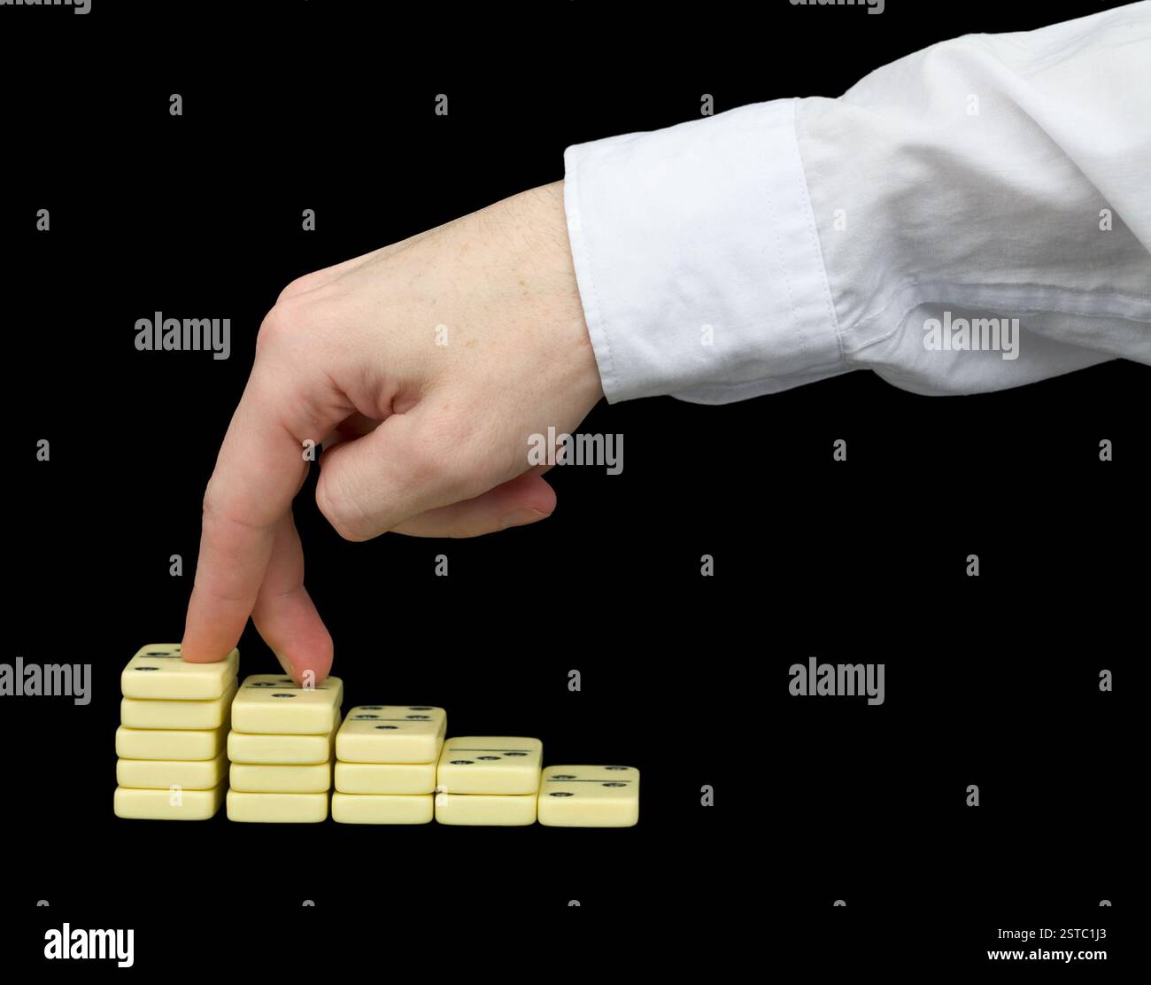Ascension on a pedestal from dominoes Stock Photo