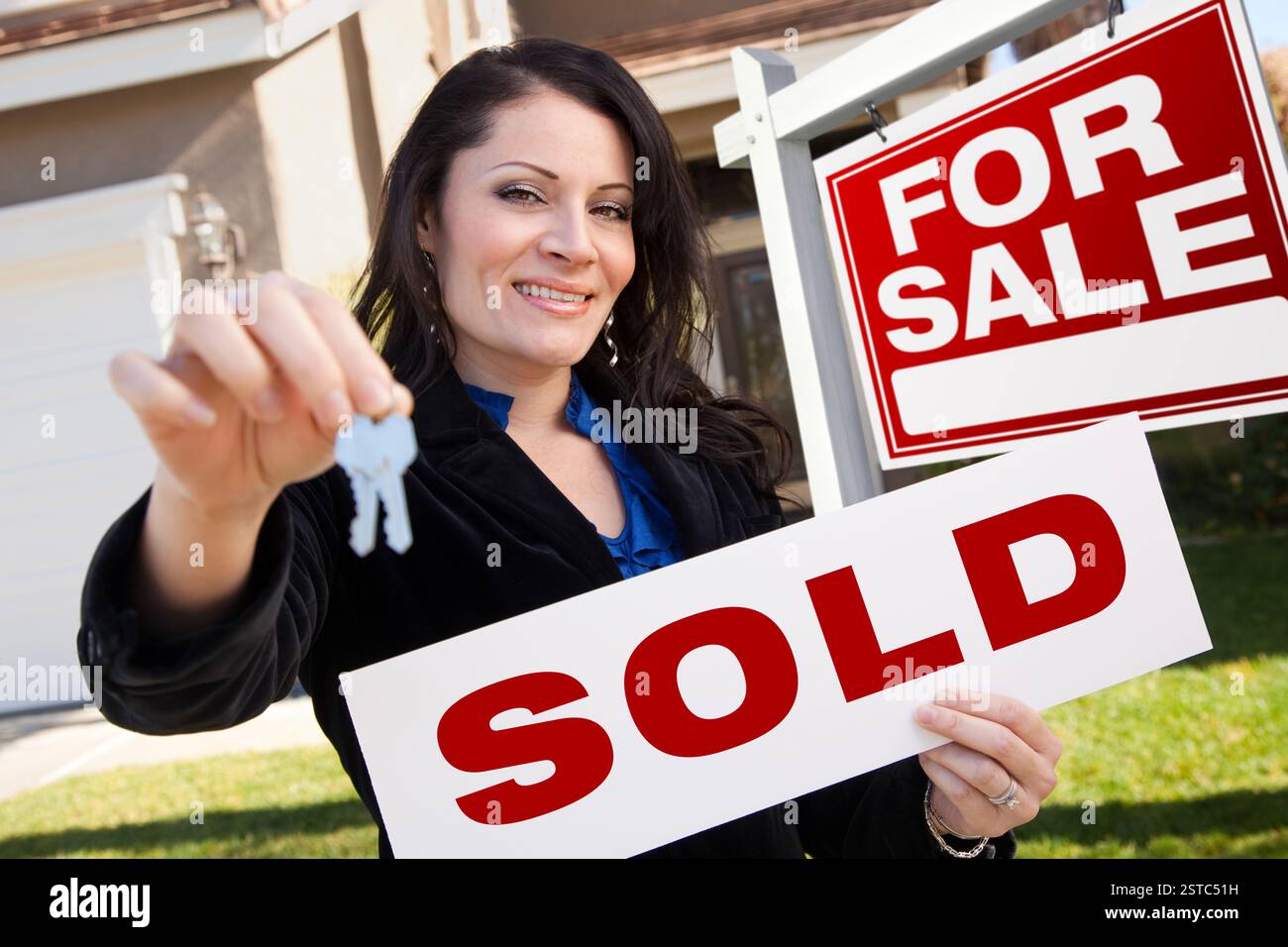 Hispanic Woman Holding Sold Real Estate Sign and K Stock Photo - Alamy