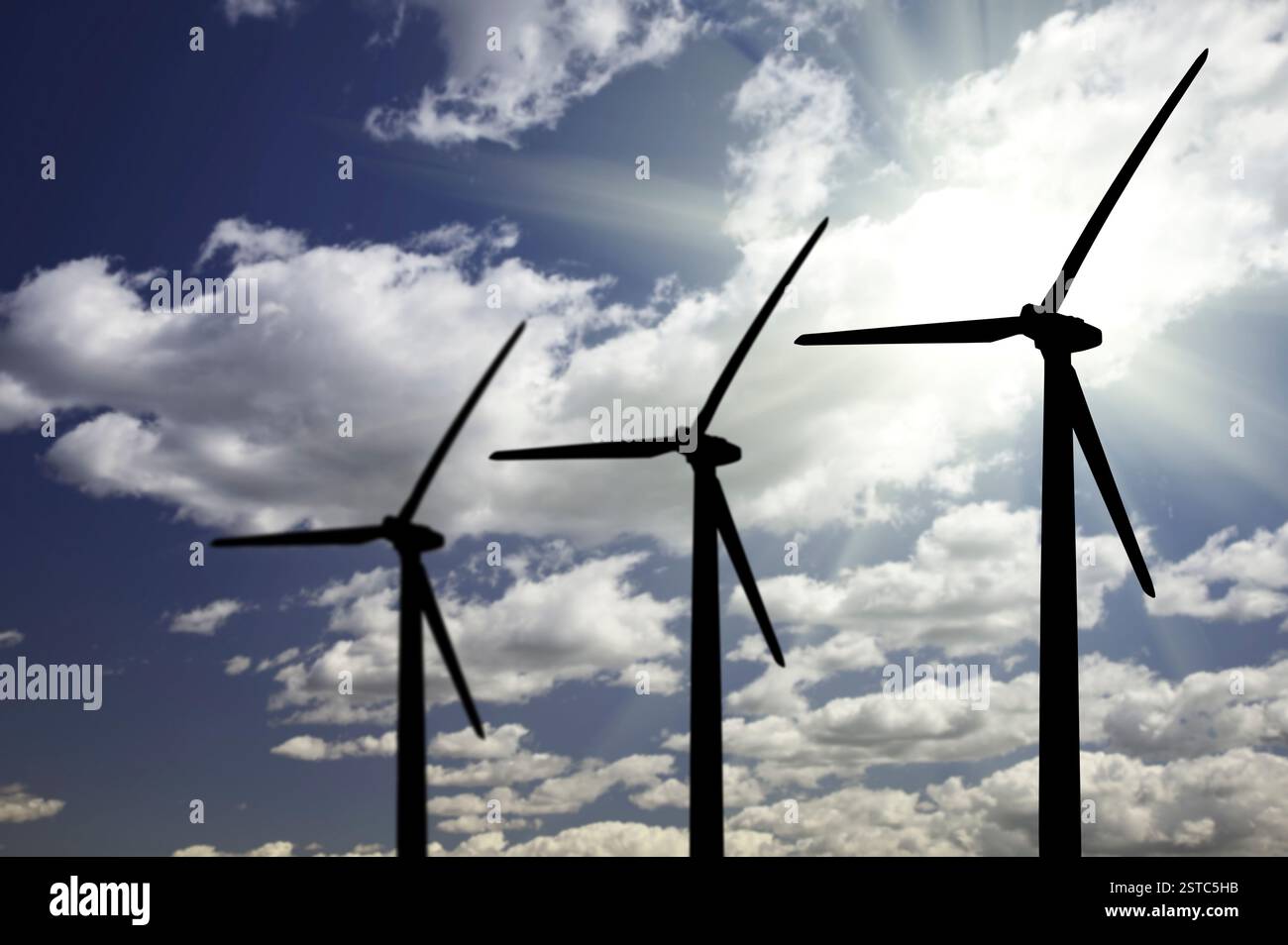 Silhouetted wind turbines over dramatic sky and clouds hi-res stock ...