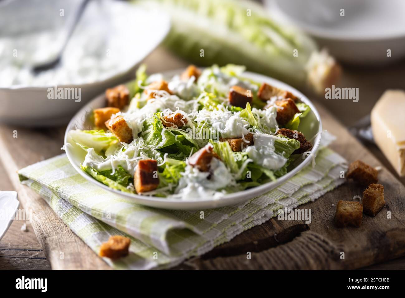 Healthy Caesar salad made with Romaine lettuce, croutons, tzatziki dressing and parmesan cheese.  Traditional Mediterranean Caesar salad originating f Stock Photo