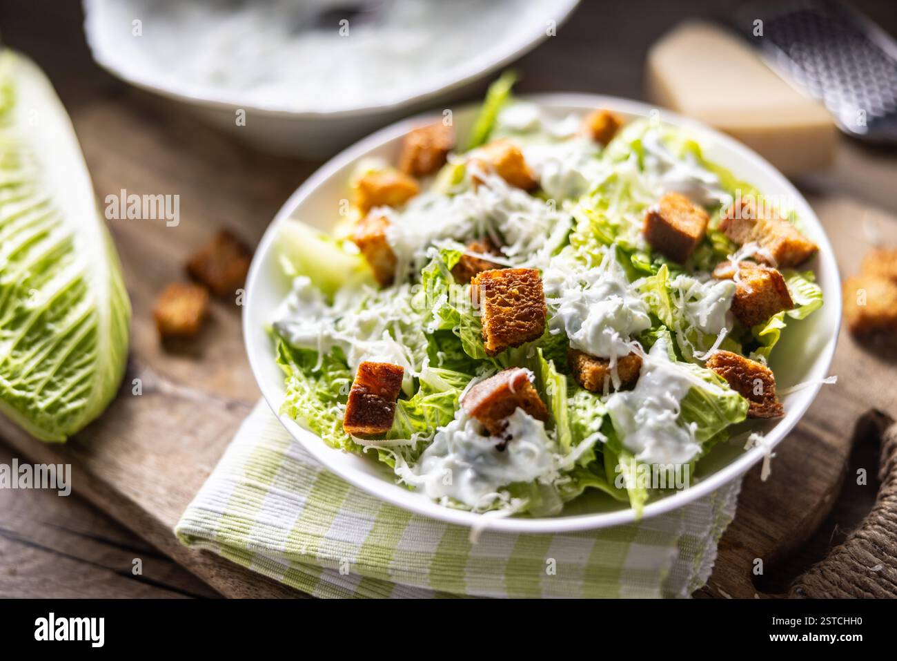 Healthy Caesar salad made with Romaine lettuce, croutons, tzatziki dressing and parmesan cheese.  Traditional Mediterranean Caesar salad originating f Stock Photo
