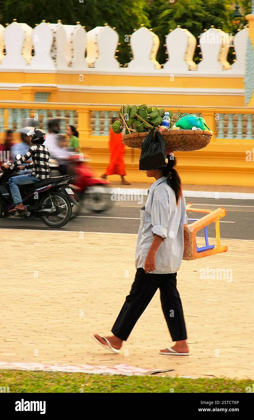Cambodian woman carrying basket on her head hi-res stock photography ...