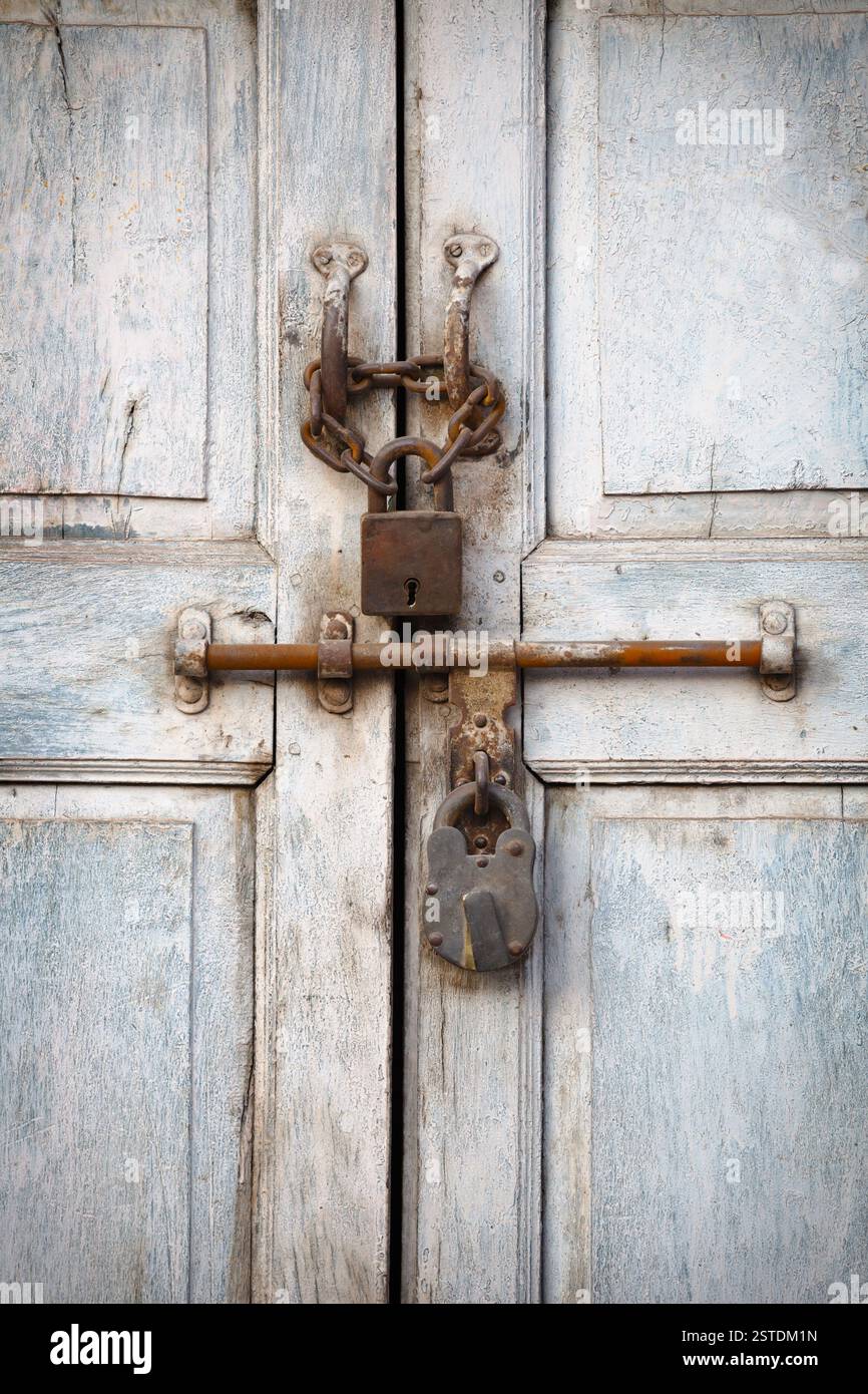 Two padlocks on the old door Stock Photo