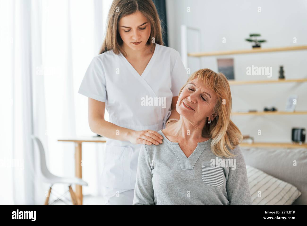 Neck massage. Senior woman is visiting physician in the office Stock ...