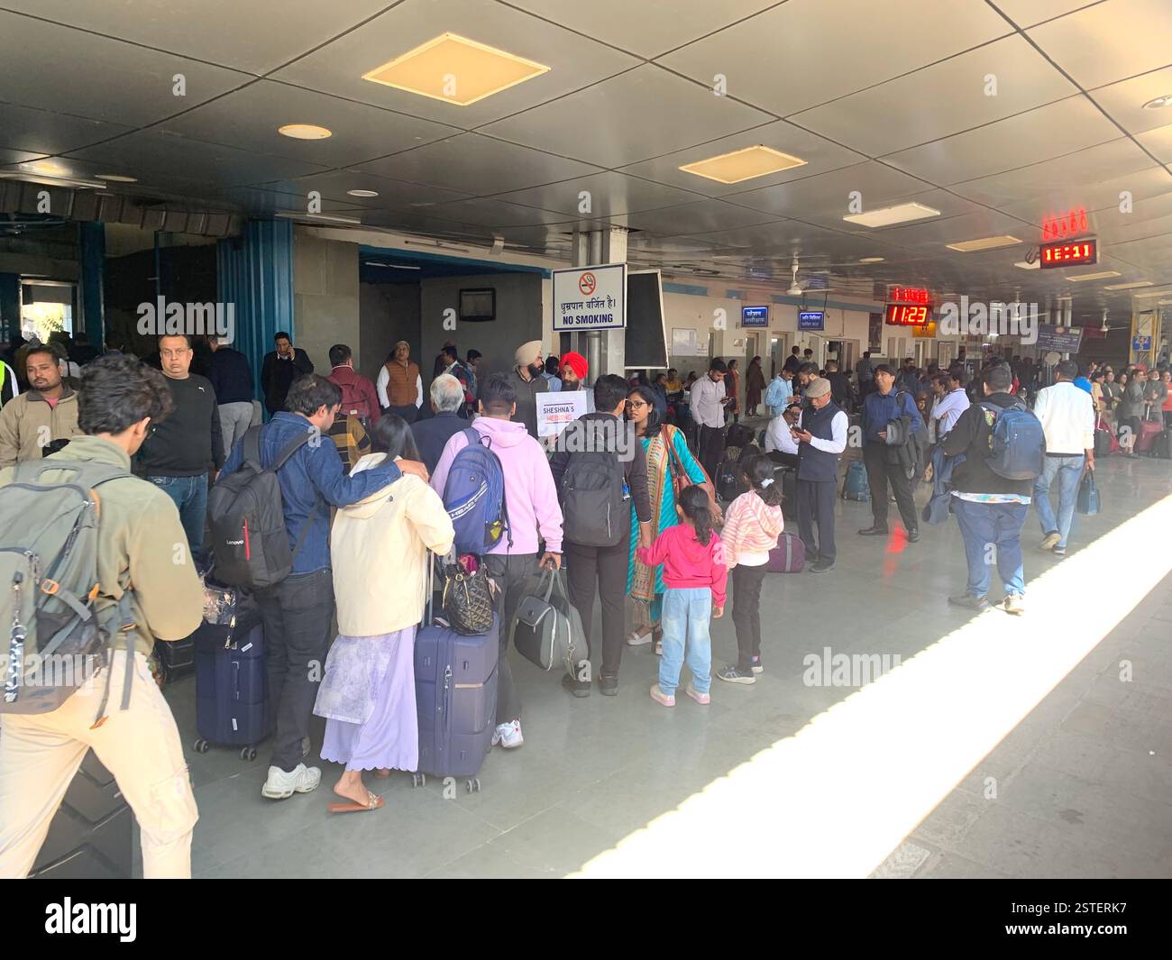 Delhi railway station India people travelling travel travellers suitcases  walk rush run hurry busy platform men women boys girls girl boy Summer - Smartphone Captured Stock Image