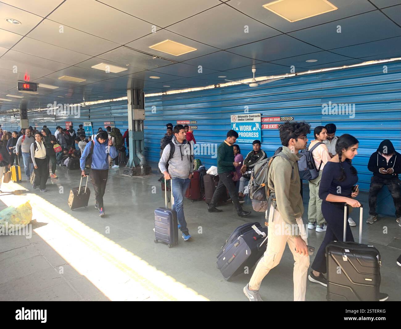 Delhi railway station India people travelling travel travellers suitcases  walk rush run hurry busy platform men women boys girls girl boy Summer - Smartphone Captured Stock Image