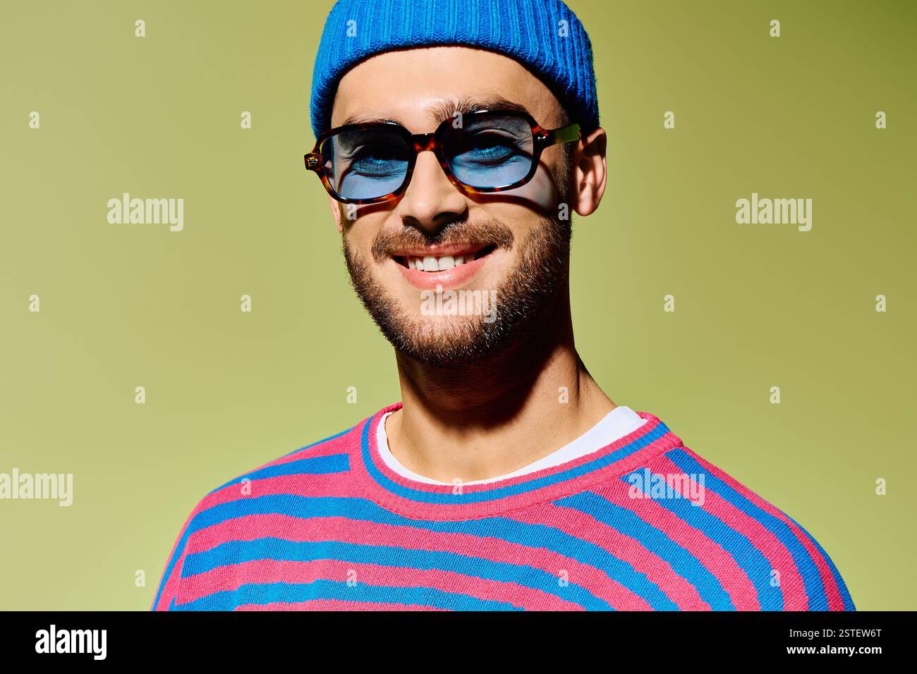 Handsome young man confidently poses in a trendy outfit with vibrant ...