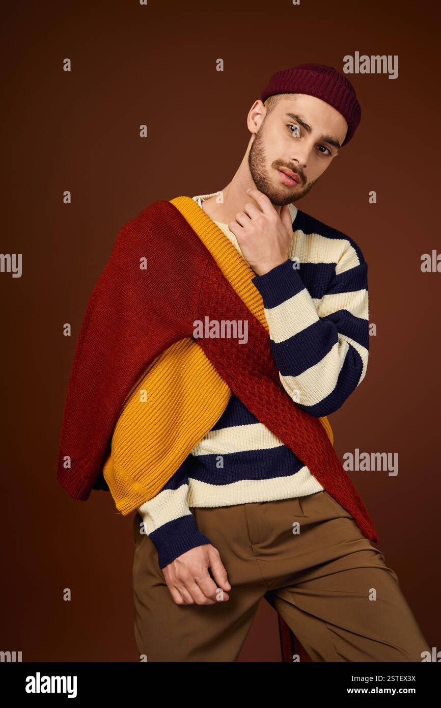 Stylish young man dons a fashionable outfit with layers and a beanie ...
