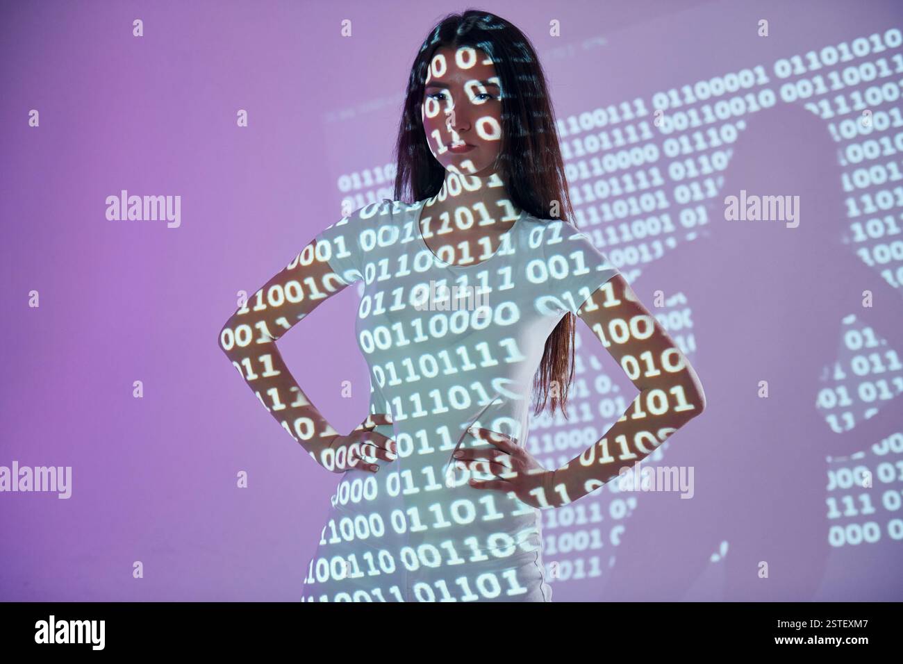 Binary machine code. Beautiful young woman is in projector neon lights in the studio. Stock Photo