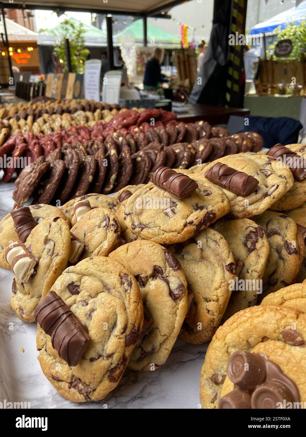 Delicious freshly baked cookies topped with chocolate bars at a market in Howth, Ireland. A sweet treat by the seaside. Stock Photo