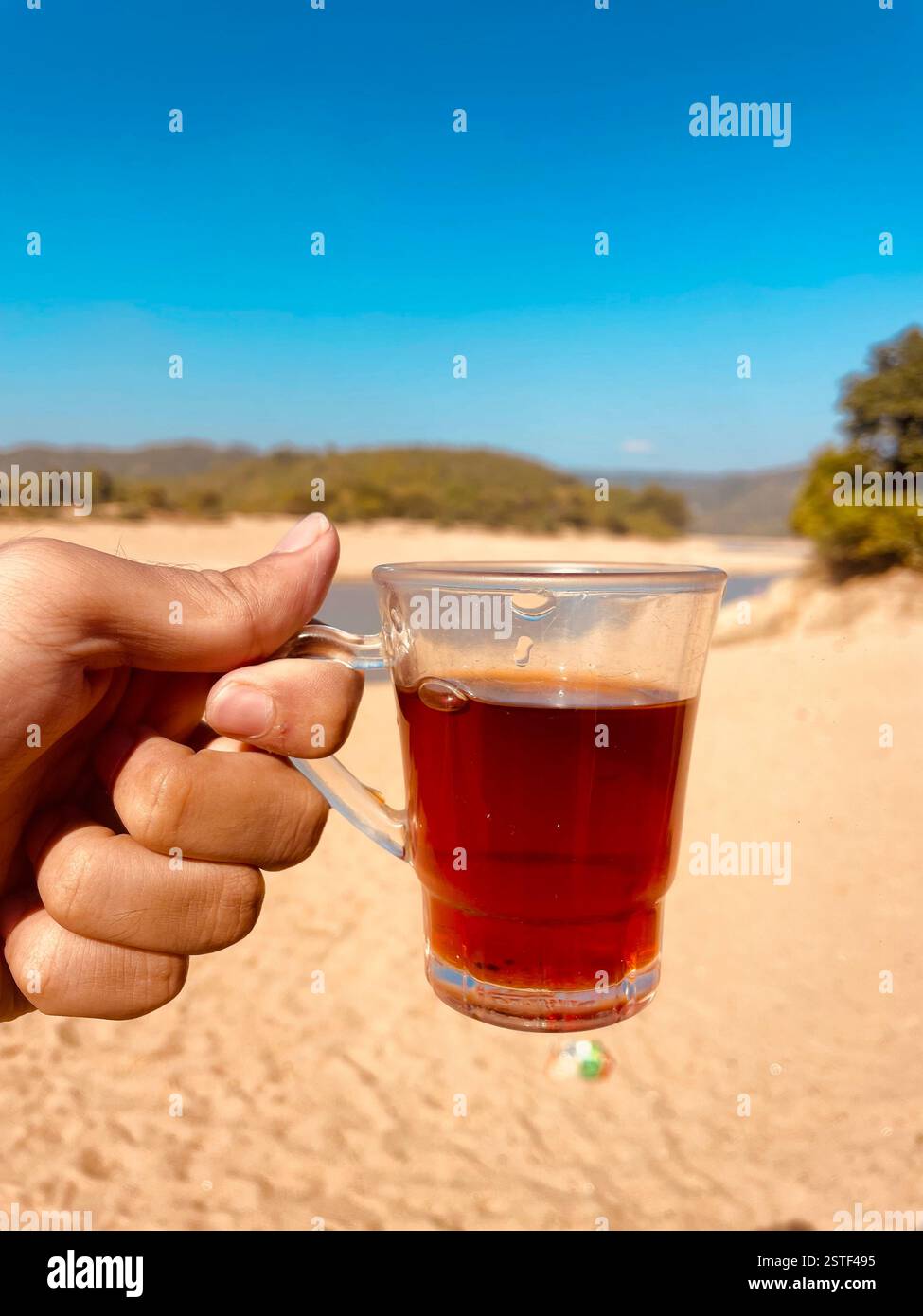 handful cup of red tea - Smartphone Captured Stock Image