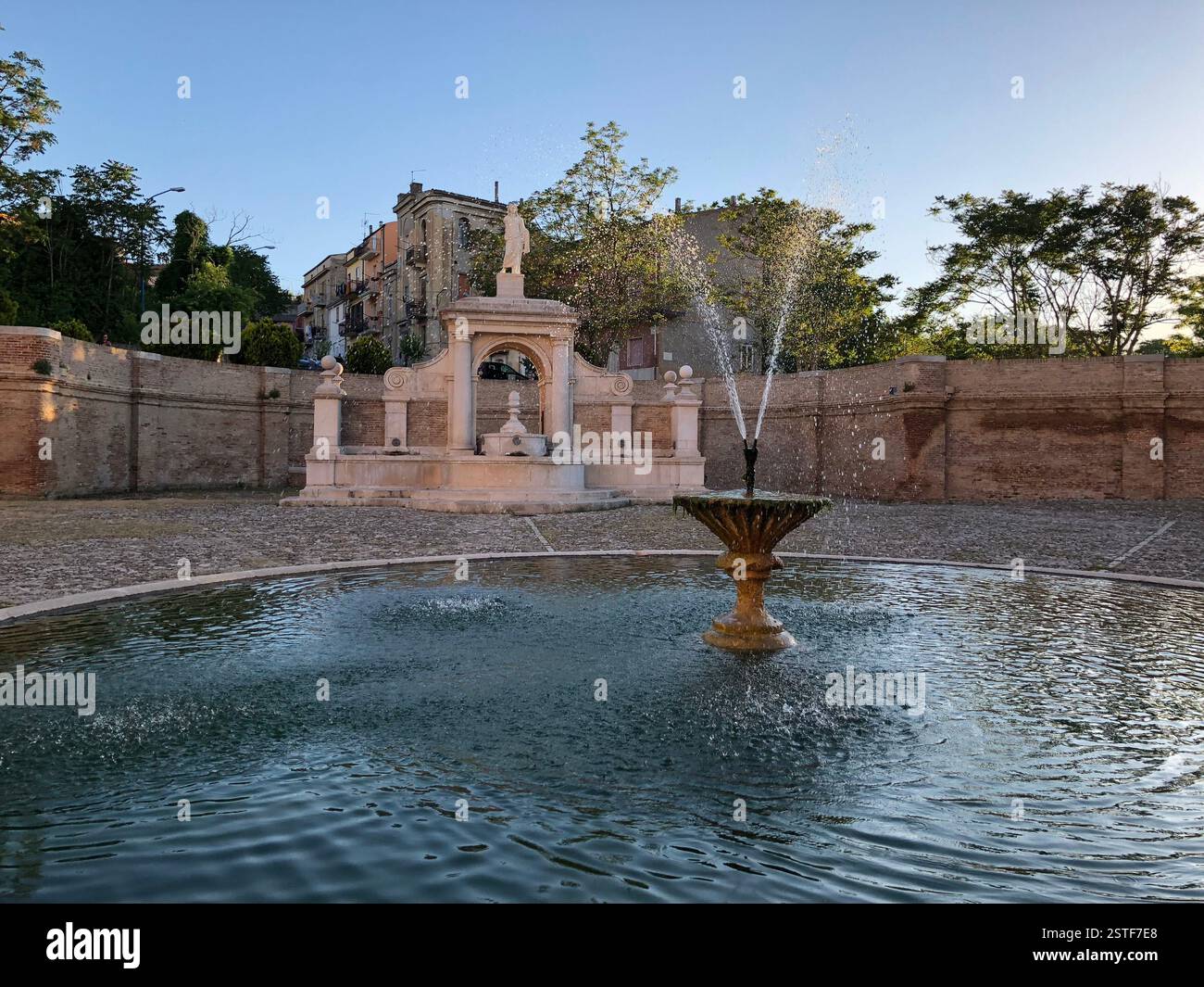 Genzano (Basilicata): Historic fountain surrounded by serene landscape in a charming village at sunset Stock Photo