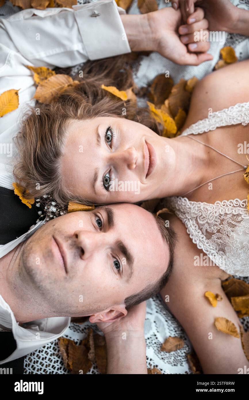 Wedding couple lying under a tree Stock Photo