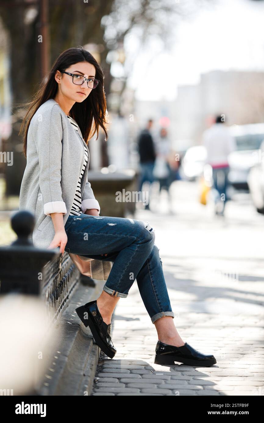 Beautiful model in a coat and glasses Stock Photo - Alamy