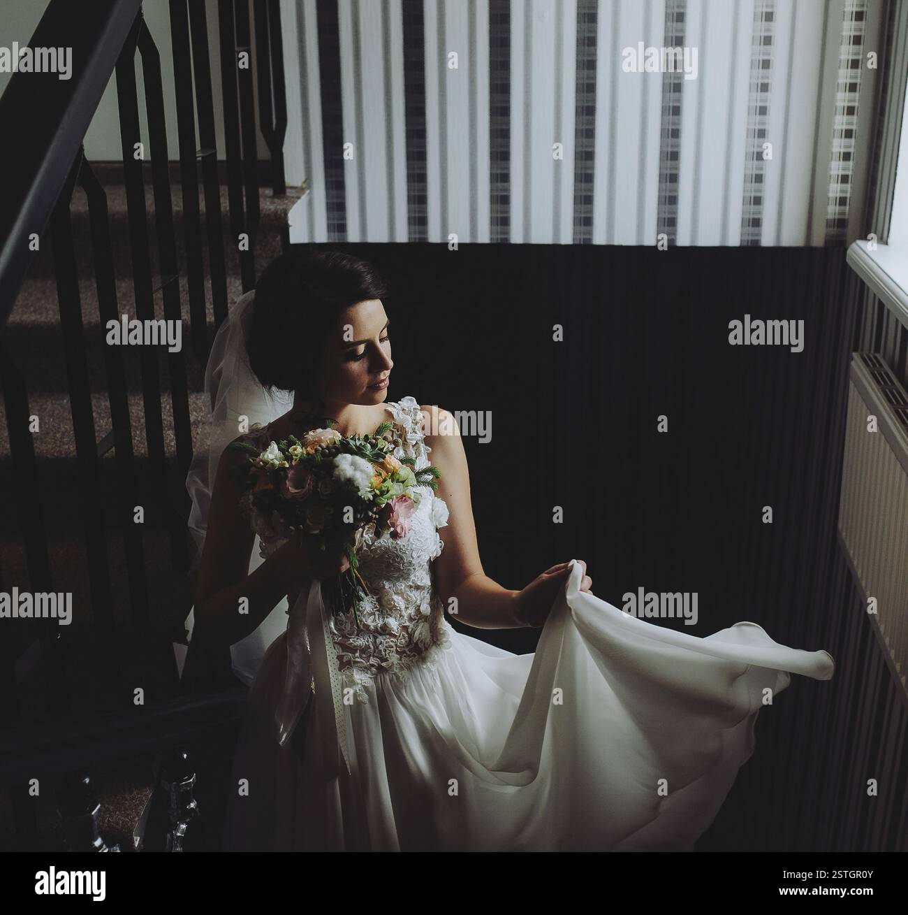 Bride posing on the stairs to the chamber hi-res stock photography and ...