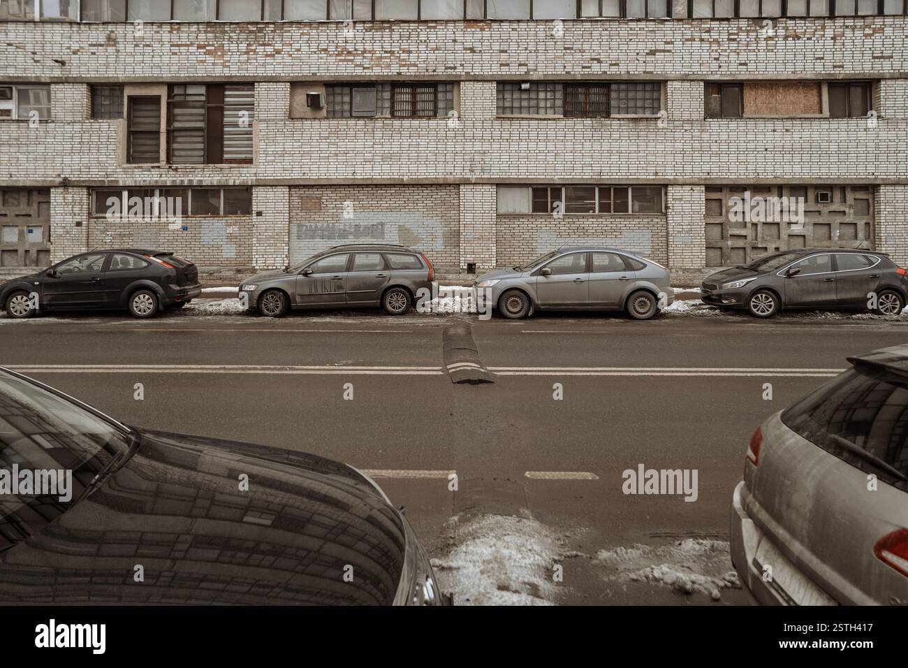 Empty lanes of city street and parked cars on both sides Stock Photo ...