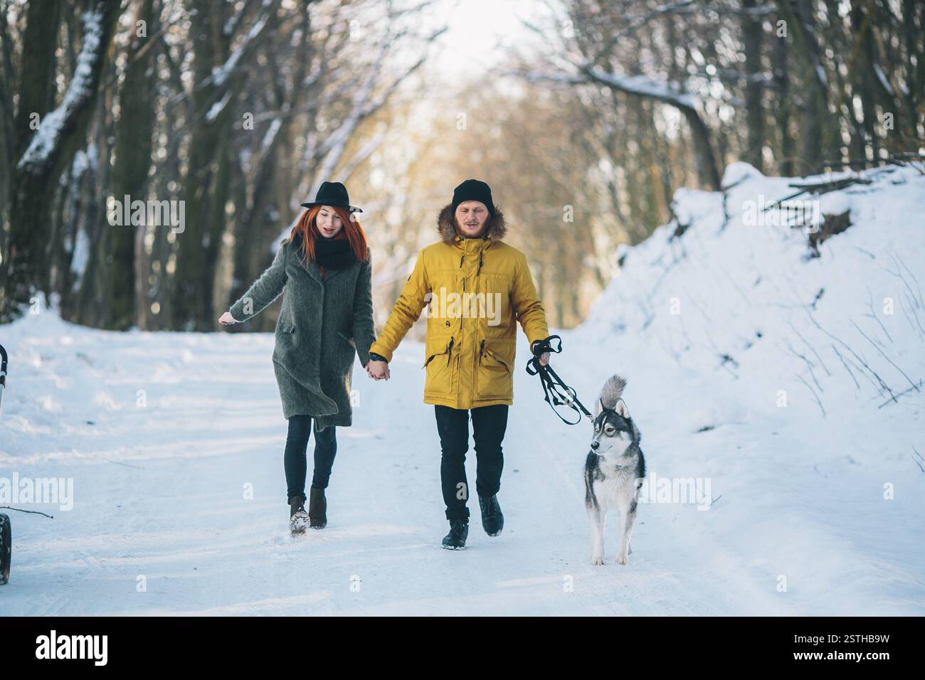 Couple with dog walking in the park in winter Stock Photo - Alamy