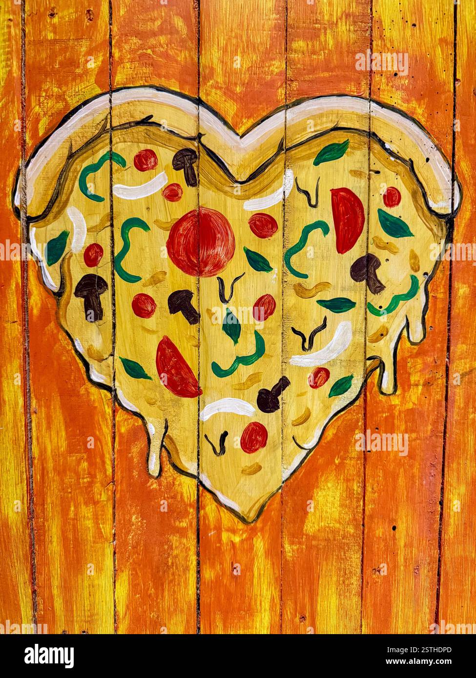 Heart-Shaped Pizza on Wooden Board A hand-painted heart-shaped pizza on a wooden board. The artwork creatively captures the love for food with vibrant - Smartphone Captured Stock Image