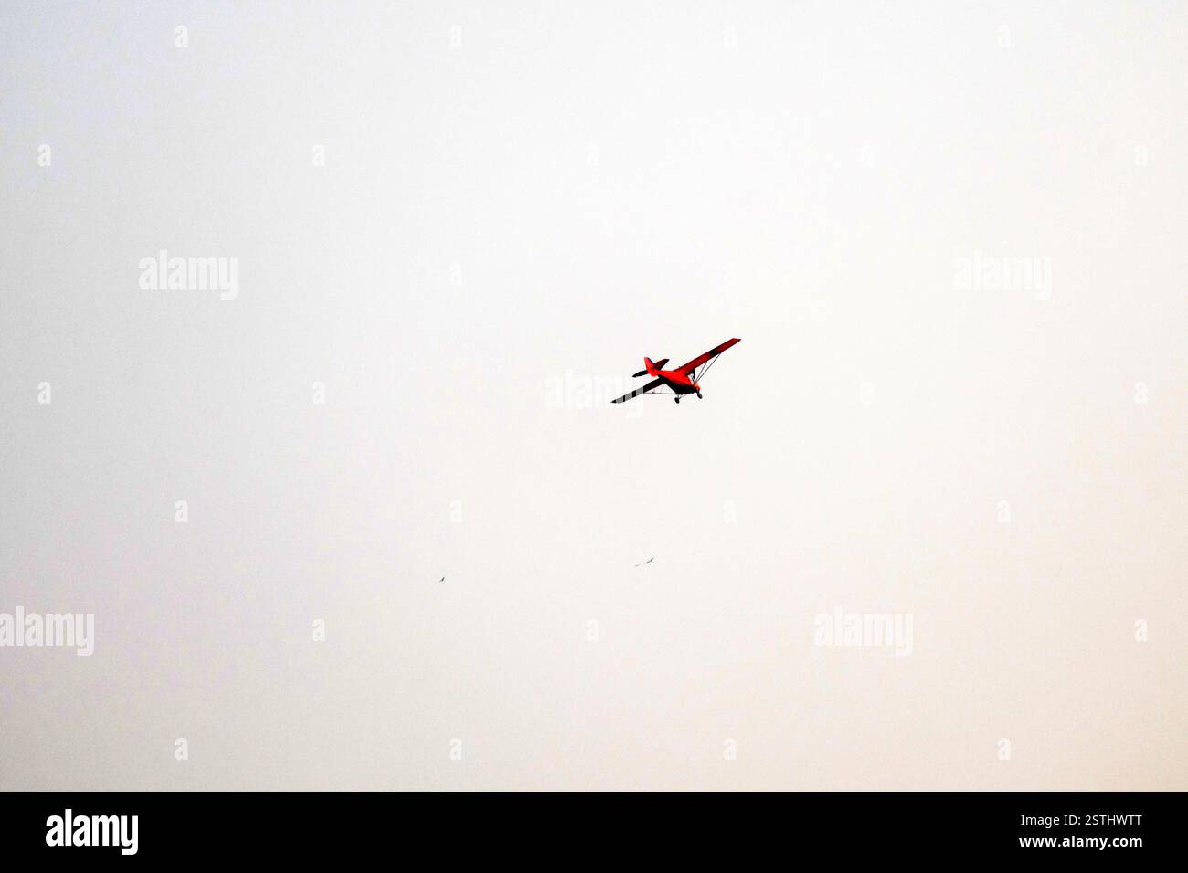 Propeller plane is flying on isolated white background Stock Photo