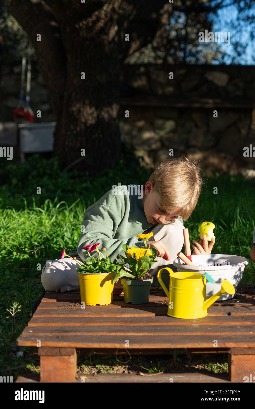 Boy watering plants in garden hi-res stock photography and images - Alamy